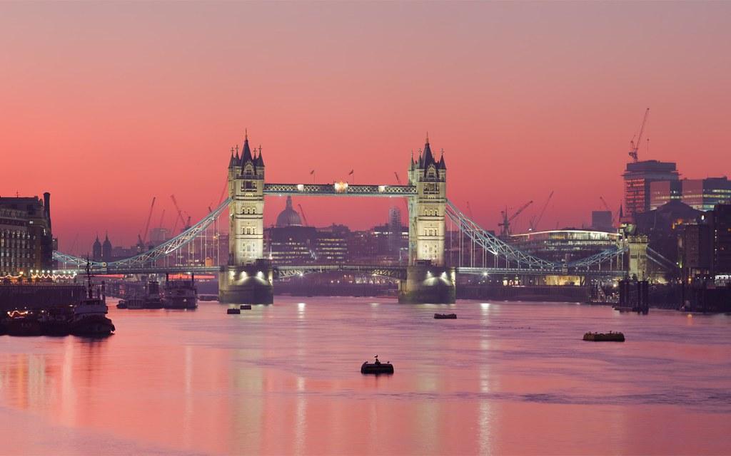 Pink and blue sunset above the Thames and Westminster in London.